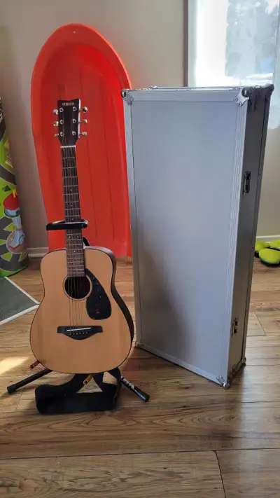 Used Yamaha acoustic guitar. Includes stand and customized case. Great for beginners.