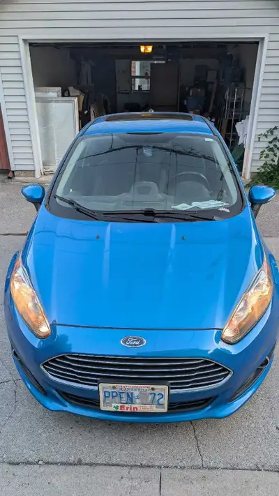 This 2015 Ford Fiesta Titanium is a reliable, fuel-efficient compact sedan featuring a smooth automa...