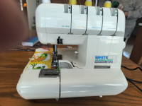 SEWING MACHINE:  WHITE SUPER LOCK SERGER WITH 50 THREAD SPOOLS