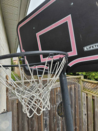 Adjustable basketball net