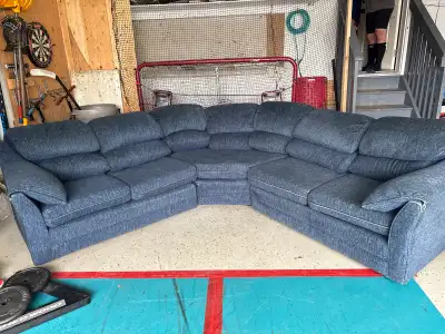 This blue fabric sectional couch is a comfortable and spacious seating solution for your garage, sho...