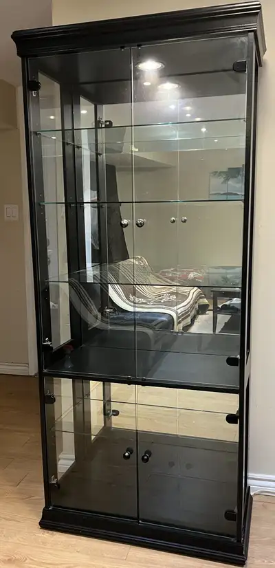 Great condition like new, black color, 4 glass doors and removable shelves, interior back mirrored a...