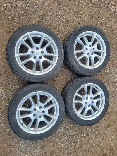 Selling a set of Nissan 18-inch aluminum wheels with a 5-bolt pattern, complete with Michelin winter...
