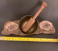 Vintage singing bowl and quartz geodes mounted on old wood.