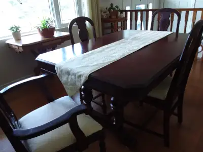 Dark stain dining table with 5 side chairs and one arm chair
