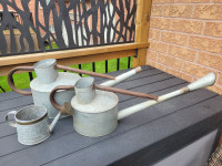 TWO VINTAGE WATERING CANS