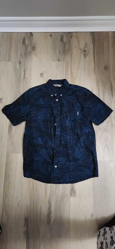 Add a touch of the tropics to your wardrobe with this Carhartt Cayman Shirt! This stylish button-up...