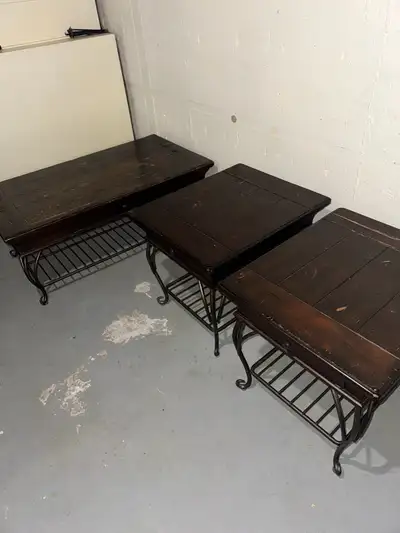 This set includes a coffee table and two side tables, each featuring a dark wood finish and a unique...