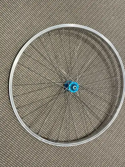 Excellent condition. Straight rim, smooth cartridge bearings. Blue Anodized Ringle Hub, QR style Sun...