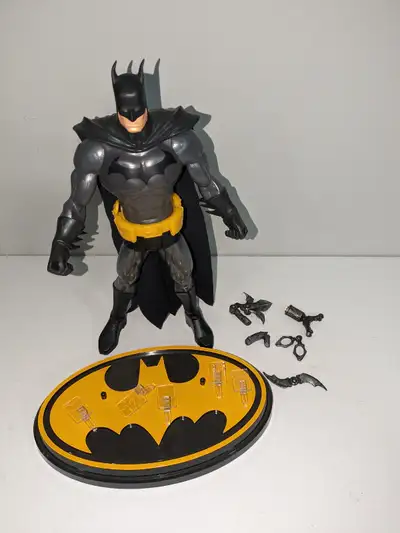 13 inch Batman action figure from Mattel. Comes complete with bat logo stand and accessories that ea...