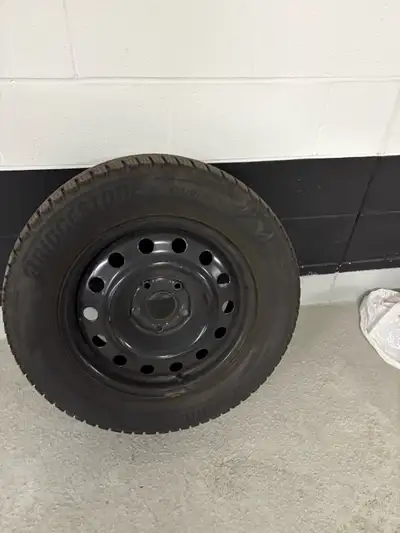 Set of Bridgestone studless winter tires mounted on black steel rims. Good tread remaining, ready fo...