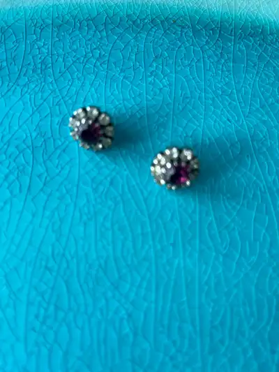 These are a pair of vintage earrings that feature a round, purple stone ( Amythyst?) surrounded by c...