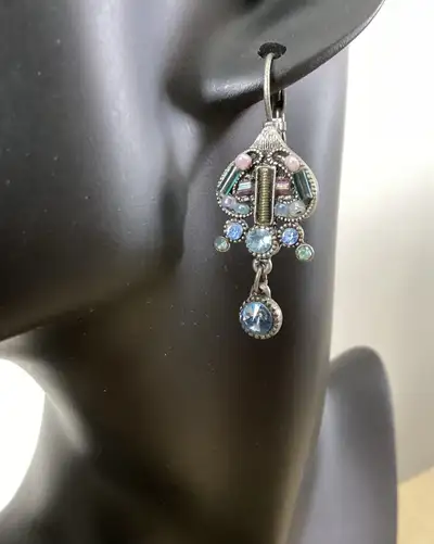 Multicoloured crystals and beads combine with silver tone metal in these lovely dangle earrings for...