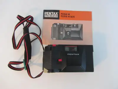 Pentax PC-35 AF-M film camera . 35 mm F2.8 lens, auto exposure, built in flash, self timer, point an...