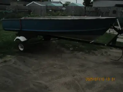 older boat and trailer , as is . rated for 25 hp motor . 1350.00
