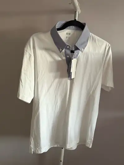 This is a brand new Uniqlo polo shirt, perfect for a smart-casual look! This stylish polo features a...