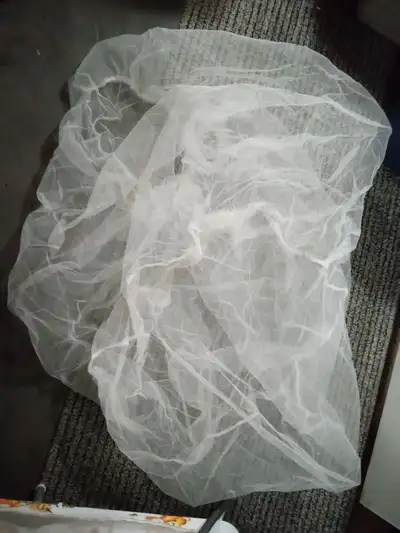 Stretch mosquito netting that can be used over strollers, beds or playpens. Located outside of Winni...