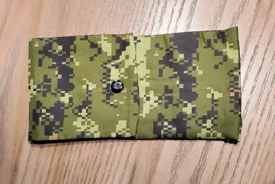 Green camo with brown polyester lining, two compartments, snap closure. Handstitched, one of a kind....
