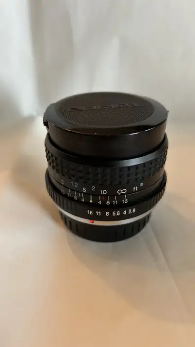 Tokina RMC 28mm f/2.8 lens, a versatile piece of photography equipment. This lens is in good conditi...
