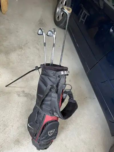 Golf bags with some clubs, View more