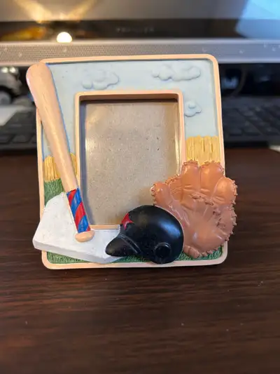 Display your cherished memories with this charming, used baseball-themed picture frame featuring a b...