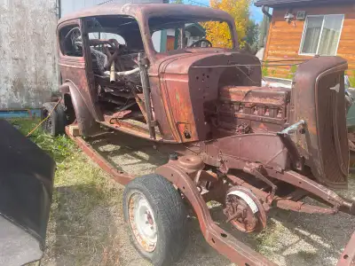 2 door Chevy sedan with potters trunk, All body are there, wood needs to be replaced, has motor, tra...