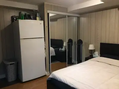 Large furnished room in bright basement with own fridge, microwave sharing kitchen and bathroom with...