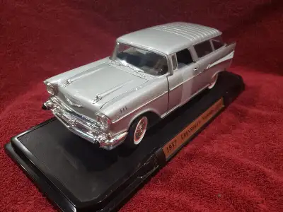 57 Chevy silver nomad 1:18 scale. Opening hood, opening doors and steerable wheels. Box has wear. Pl...