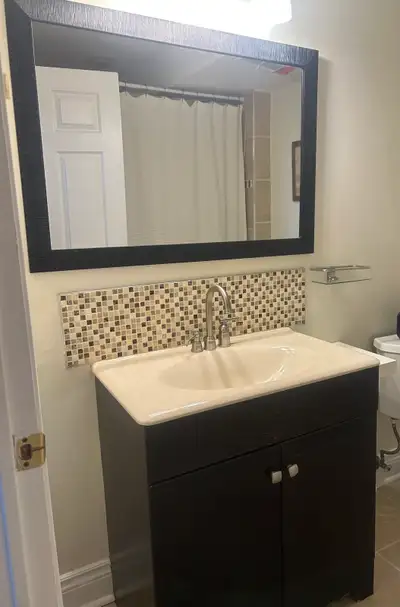 Dark vanity with light countertop with silver faucet 30” x 18” and 32” tall
