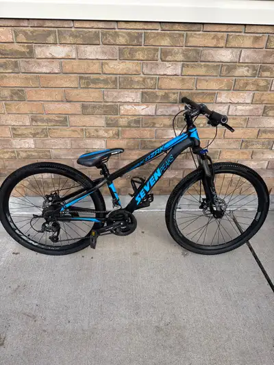 I'm selling a used Seven Peaks Kozak 13-inch mountain bike with a sturdy black and blue frame, perfe...