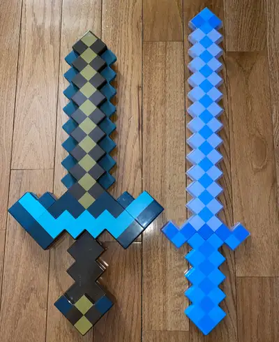 Lot of 2 Mattel Minecraft Toy Cosplay Weapons…the one on left is a 2 in 1 pickaxe and sword …with pu...