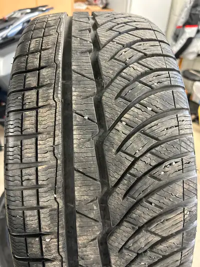 High-performance Michelin Pilot Alpin winter tires come in a set of four. These black rubber tires h...