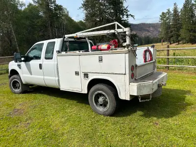 5.4L with service body. Small crane, air storage tank and hose reel. $8,500