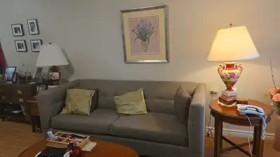 This stylish, used sofa features a durable grey fabric, offering both comfort and sophistication for...