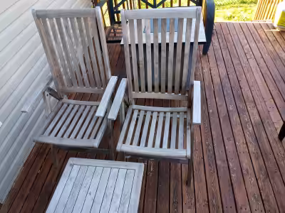 2 wooden outdoor chairs and table.
