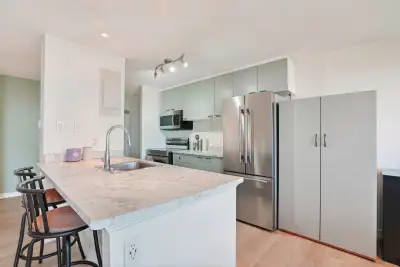 This is a two-level condo with a bright and open main level that includes a kitchen, dining area, an...