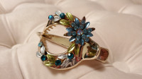 Beautiful gold-coloured hair clip with blue rhinestones