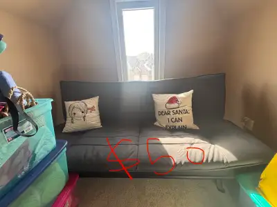 Selling a dark grey convertible futon from Structube. It’s a stylish and functional piece that easil...