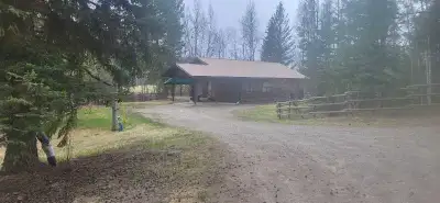 17km east of 100Mile House on pavement. Beautiful manufactured log home built in 1996. 2Acres, fence...