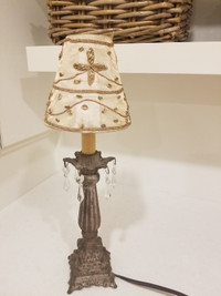 Small metal lamp with beaded shade