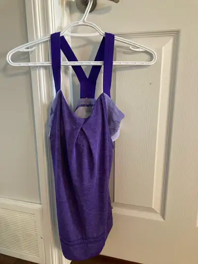 Size 4. Built in sports bra. Breathable workout tank. Sports bra top is very secure. Rest of tank is...