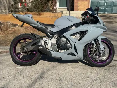 Sleek Suzuki GSX-R sportbike. The most Has a matte grey paint job with custom purple rims. Michelin...