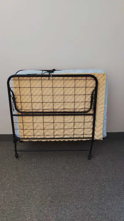 Selling a twin/single size rollaway folding bed with a clean mattress and an extra egg-crate foam pa...