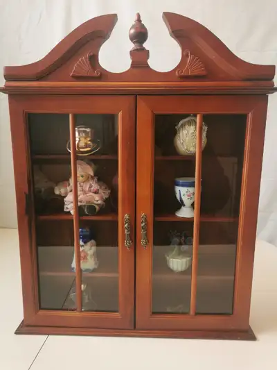 This vintage wooden display cabinet features eight vintage knick knacks Elegant glass doors, a decor...