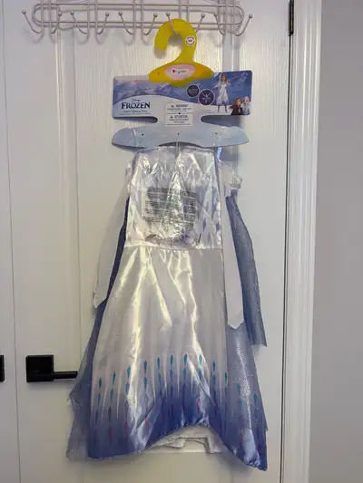 Your little one can transform into the Snow Queen Elsa with this enchanting Disney Frozen dress! Thi...