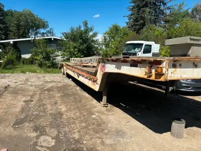 Lowboy New tires Running good Solid trailer New leaf spring CVIP exp JAN/2026 This used lowboy trail...