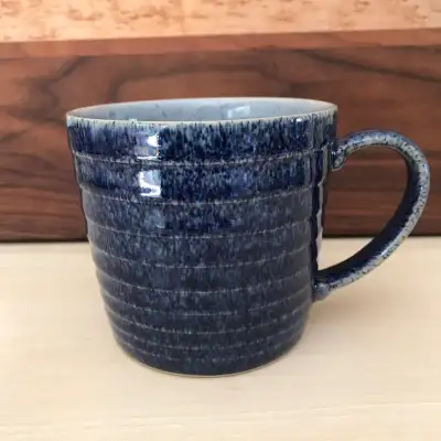 Denby 1809 Studio Blue Mug. This quality mug features a cobalt blue speckled glazed exterior and a l...