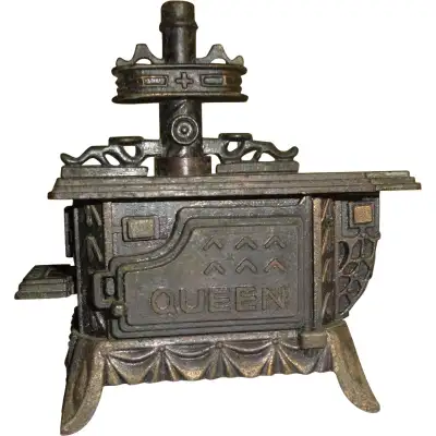 Antique finish mini pencil sharpener that really works. Stove door swings open. It fits in the palm...