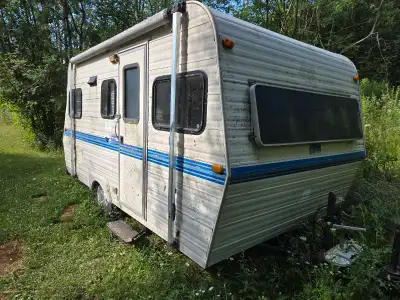15' camper trailer. The cabin is garbage but the base is in good shape to use as a flatbed trailer....
