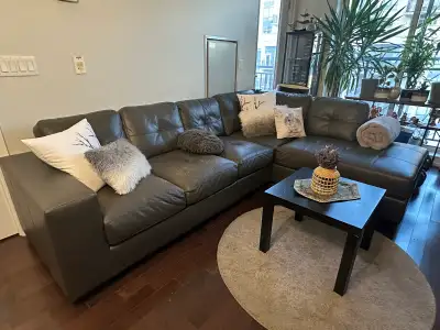 Selling a comfortable grey leather sectional sofa from Leon's. This couch is perfect for a living ro...